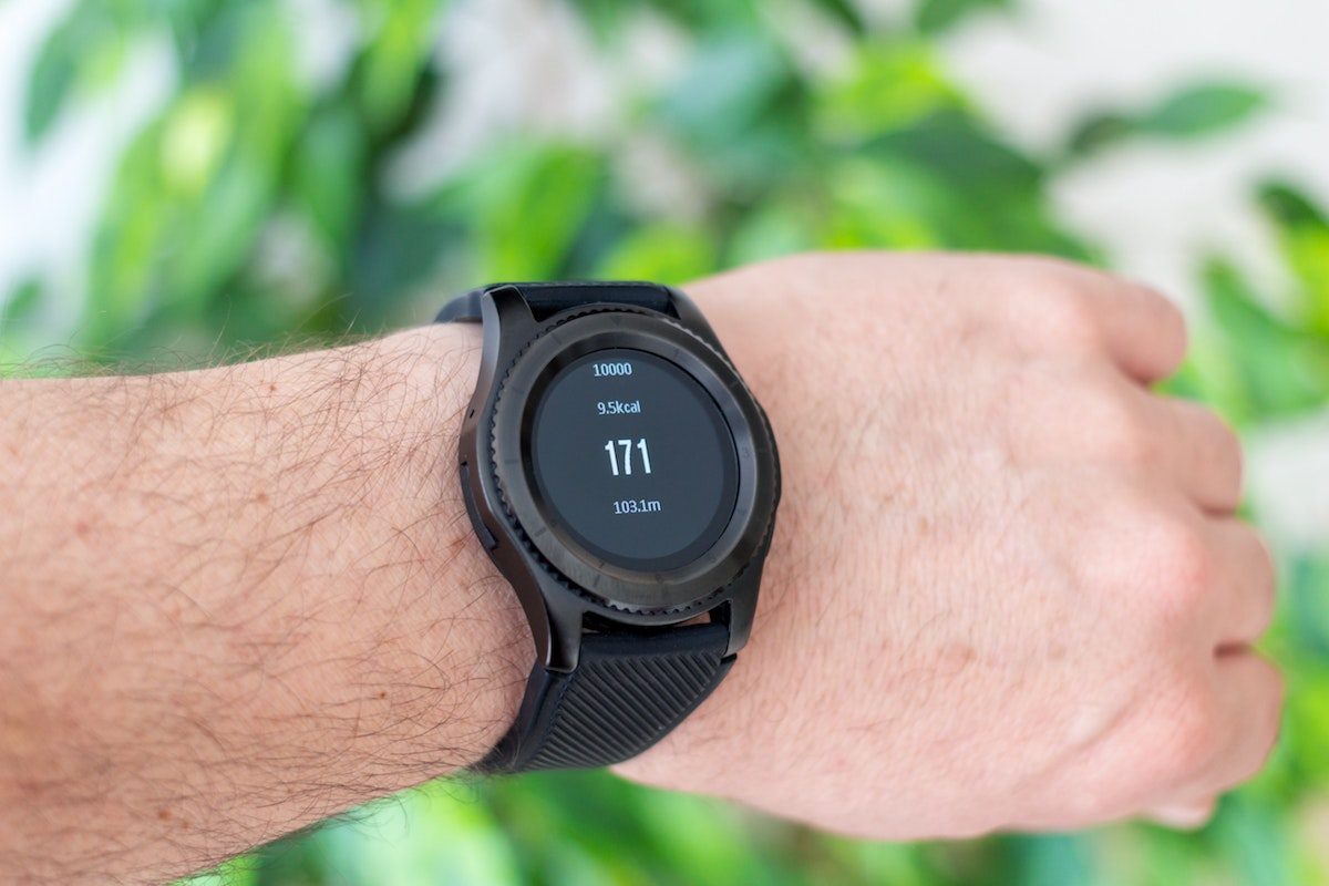 A man's wrist with a watch display aerobic heart rate.
