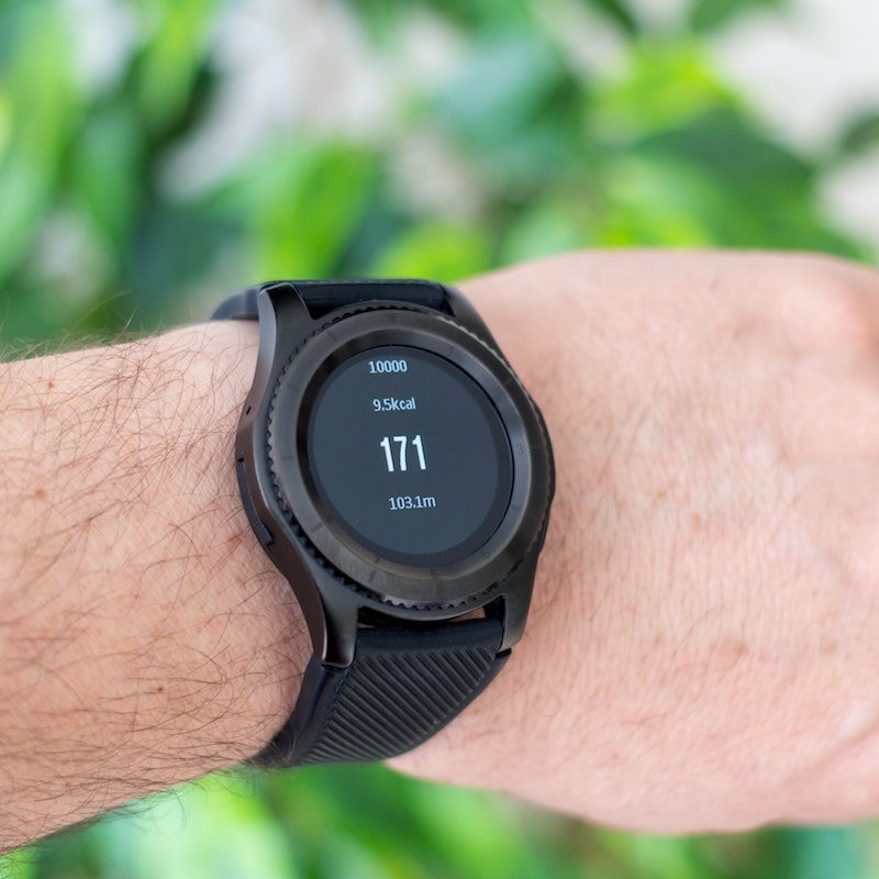 A man's wrist with a watch display aerobic heart rate.
