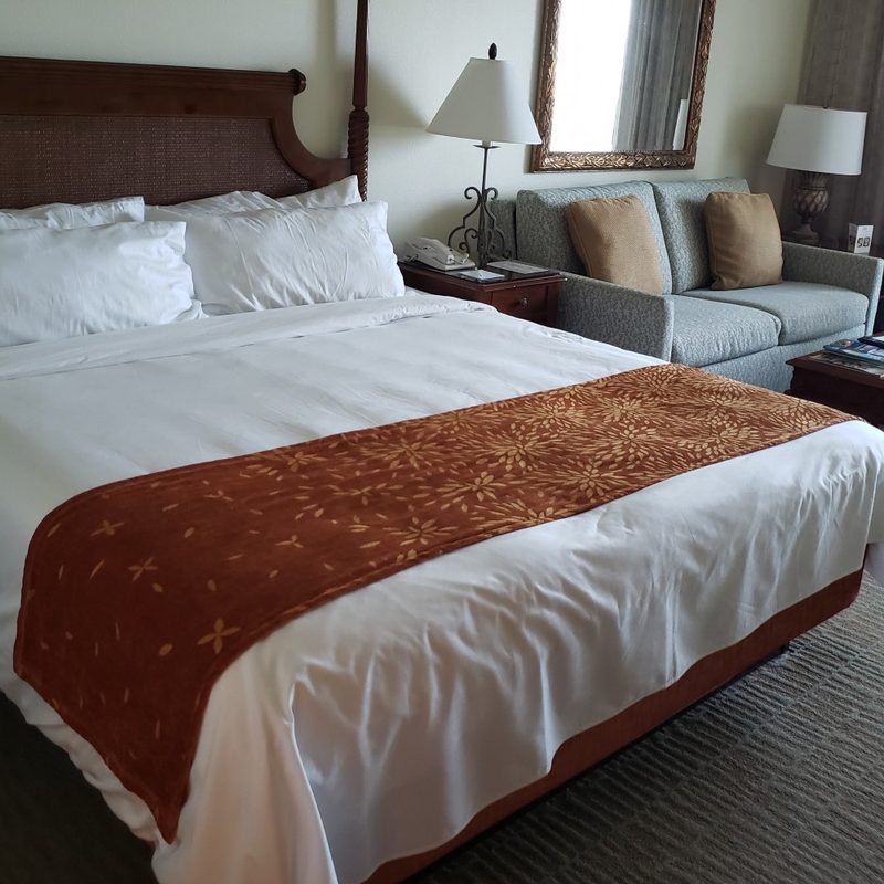A bed in a hotel room.