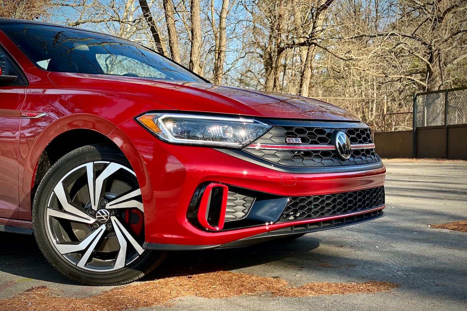 Close up of 2022 Volkswagen Jetta front end with trees in the background.