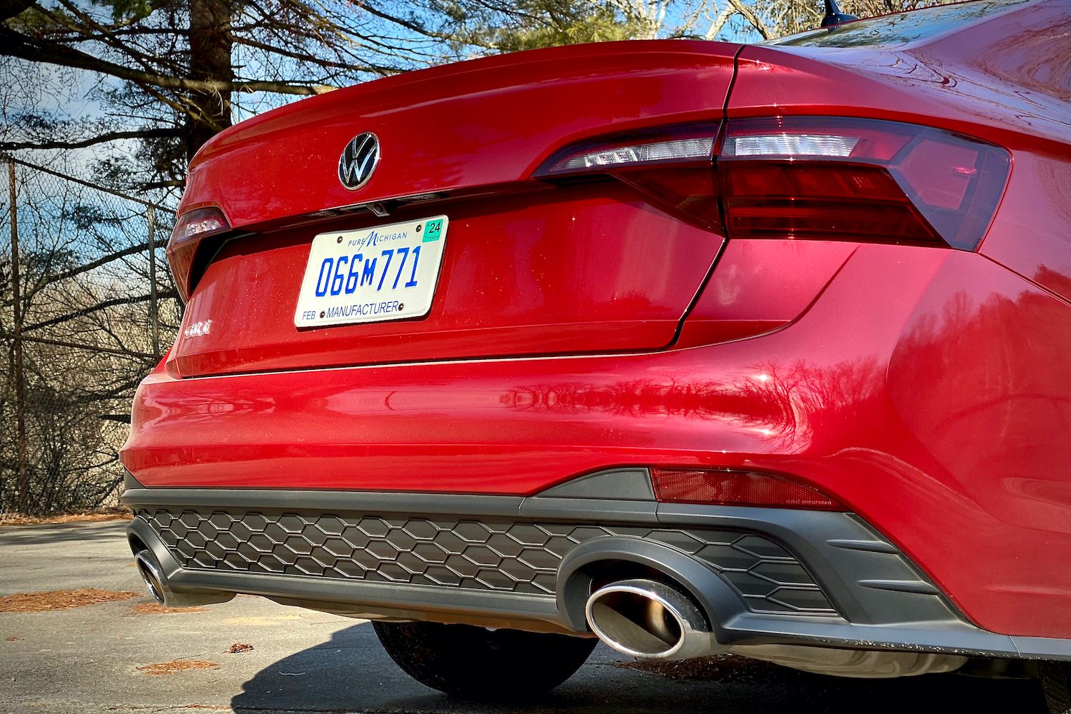 Close up of 2022 Volkswagen Jetta rear end, rear diffuser, and exhaust outlets.