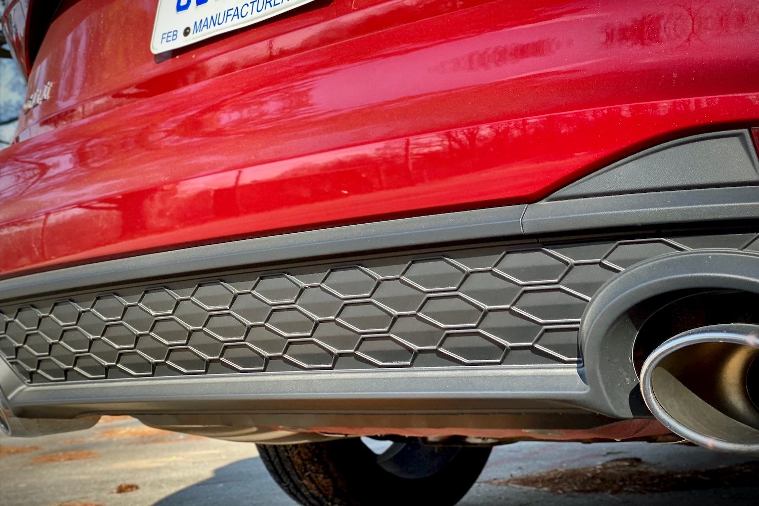 Close up of 2022 Volkswagen Jetta GLI honeycomb rear diffuser and exhause outlet.