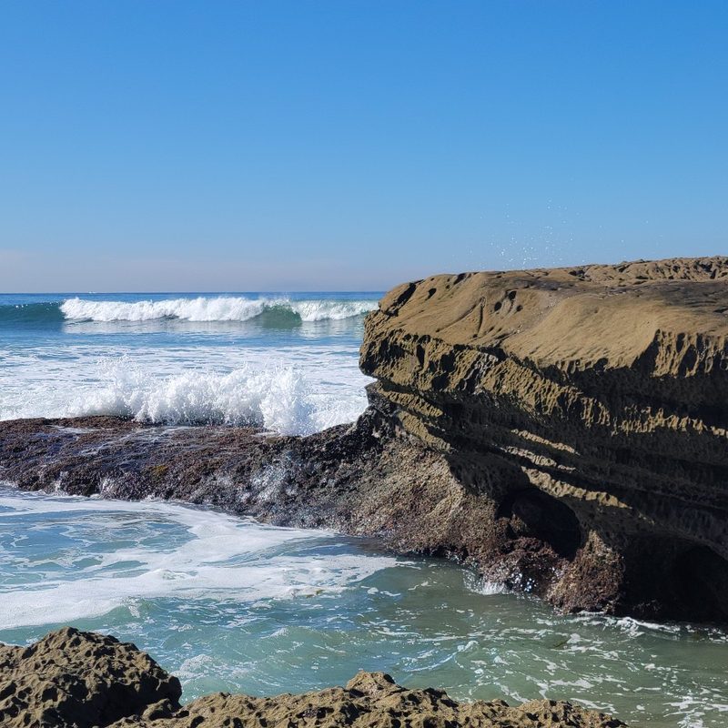 The waves approach the shoreline at the beach at Santa Cruz Cliffs in San Diego, California.