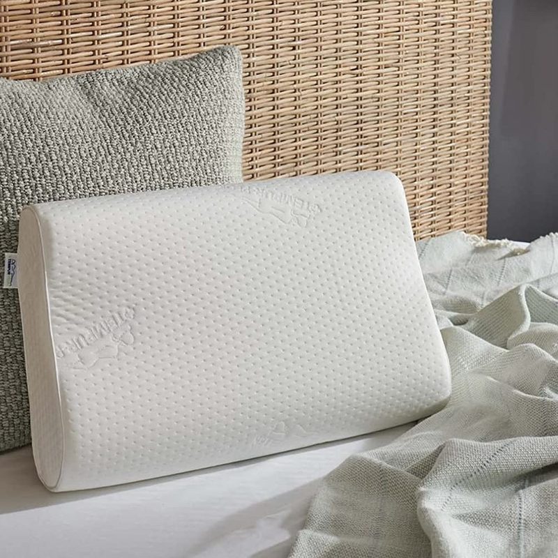 The Tempur-Pedic TEMPUR-Ergo Neck Pillow on a bed.