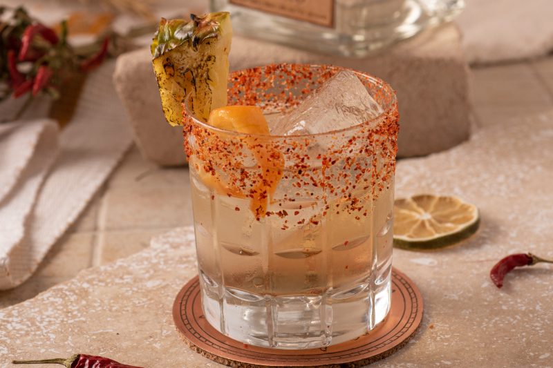 Amante Picante margarita with fruit on the rim.