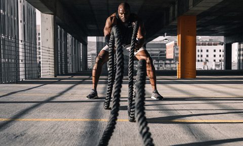 Man doing battle ropes workout.