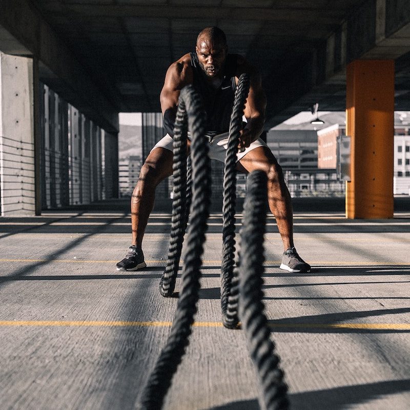 Man doing battle ropes workout.