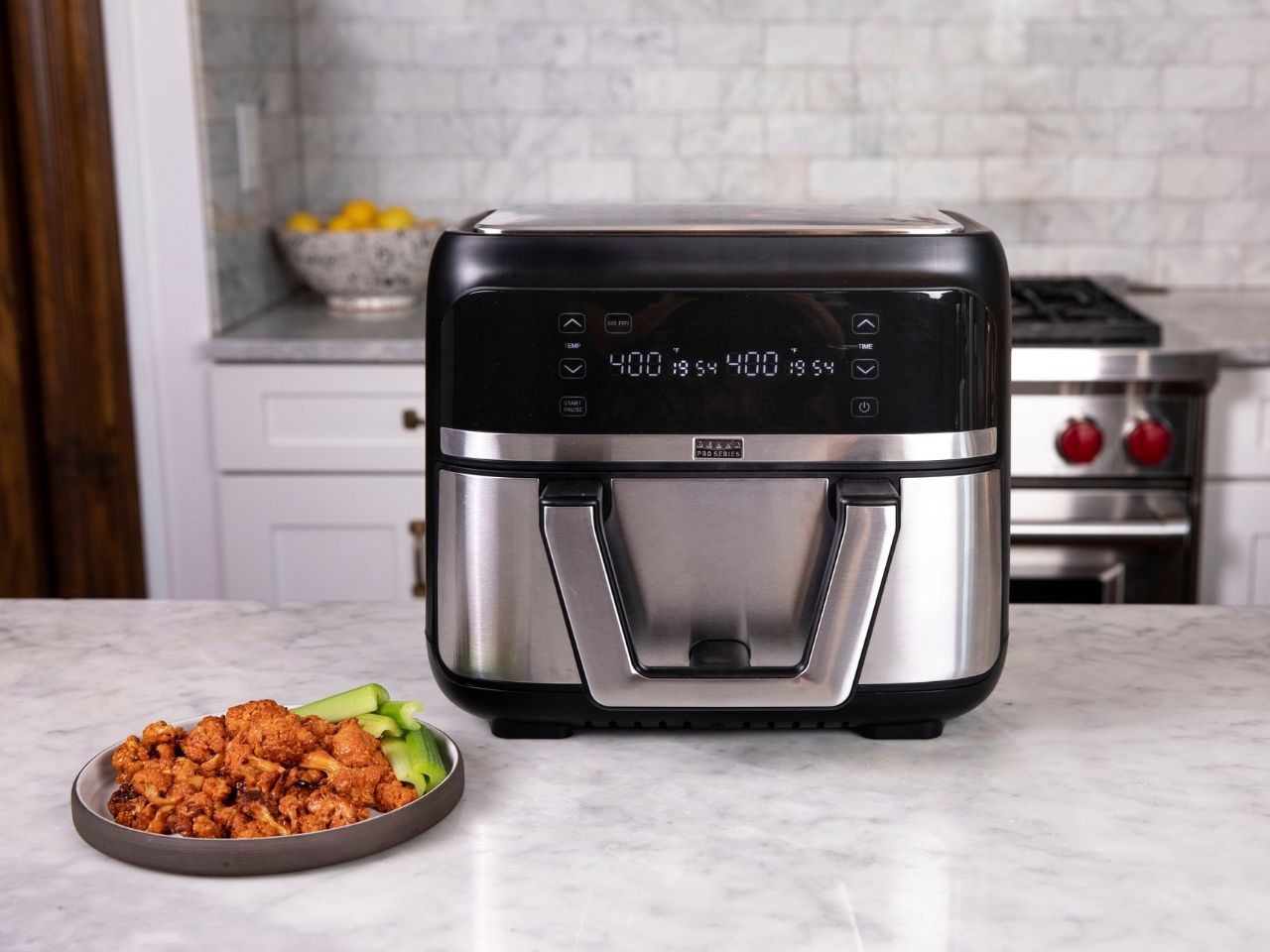 Bella Pro Series 9-quart air fryer with chicken wings on counter.