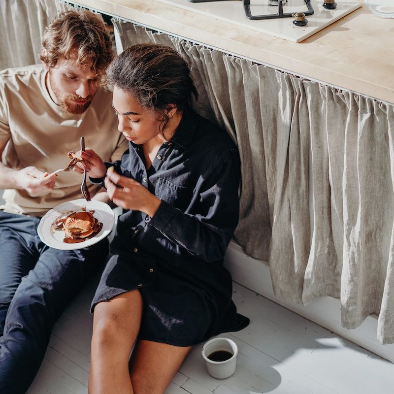 Couple sharing breakfast pancakes.