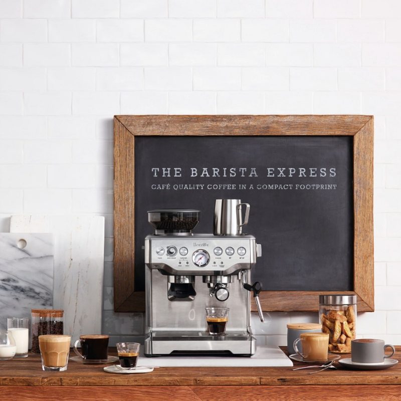 Breville's The Barista Express with beverages on a table.