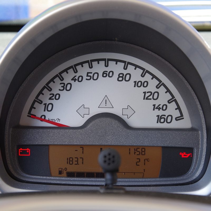 Car warning light on a vehicle dashboard.