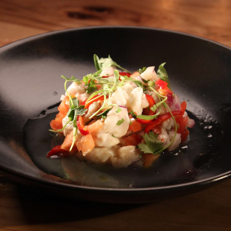CRUjiente Tacos ceviche on a black plate.