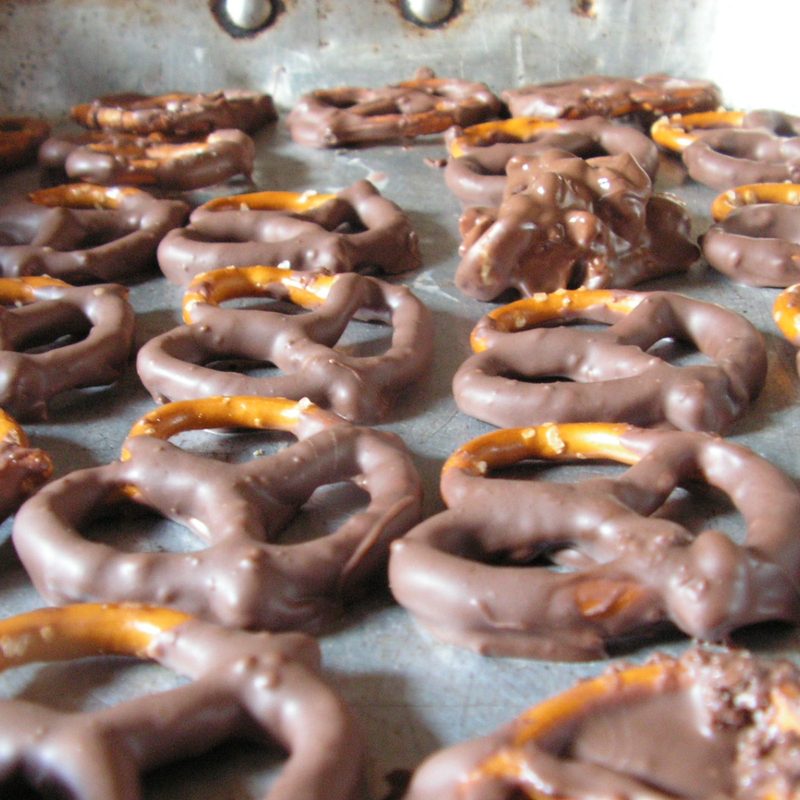 Chocolate pretzels on a metal tray.