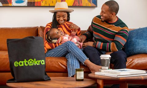 Janique and Anthony Edwards of EatOkra with son on a couch.