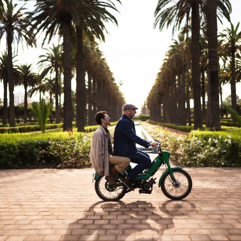 Eric Cantona (front) and photographer and Looking FC partner Karim Chater (back) on a motorbike in Casablanca.