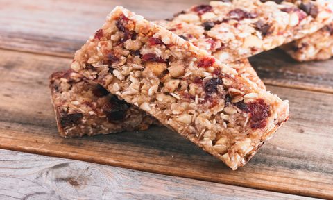 A close-up of granola bars on wooden board.