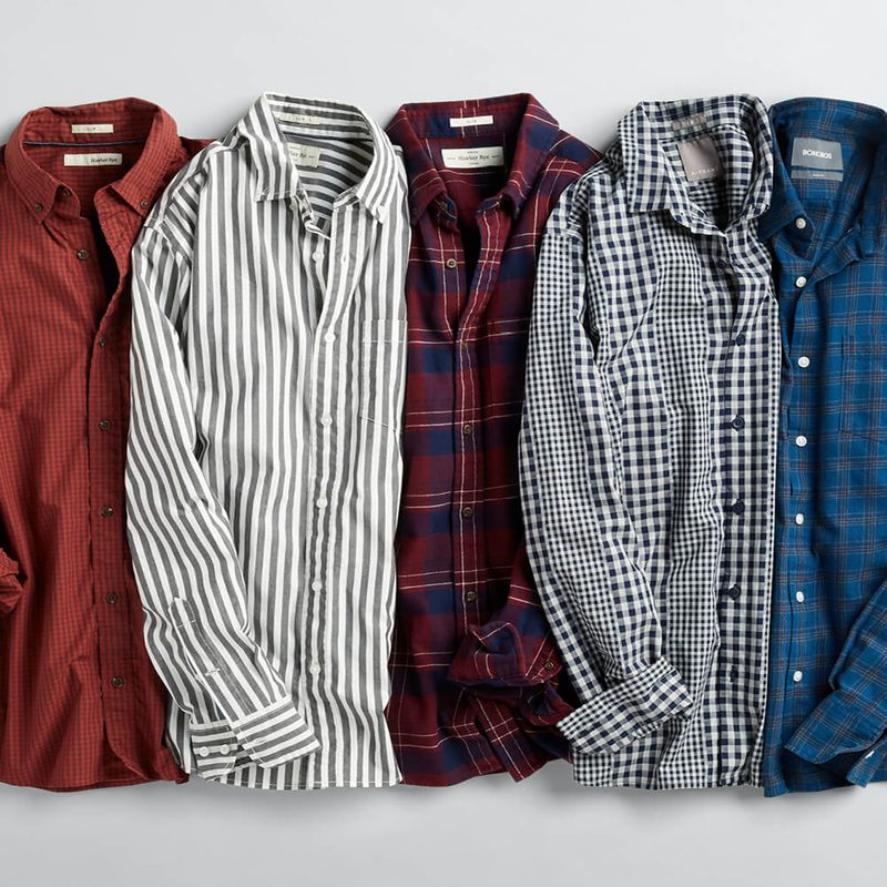 Five dress shirts on gray background.