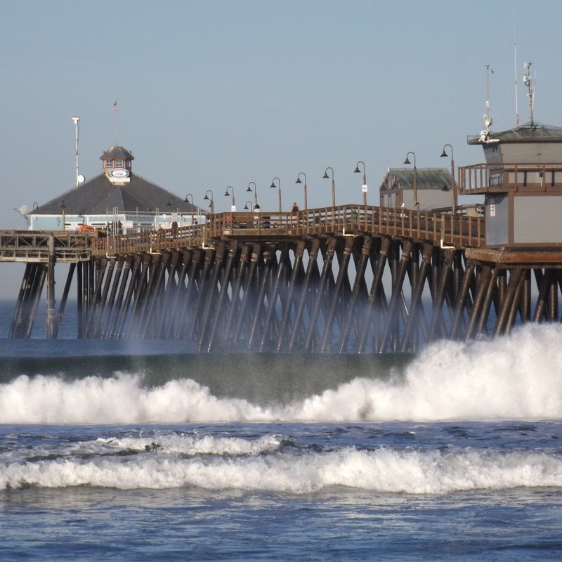 The waves crash onto the shore near the Imperial Beach Pier.