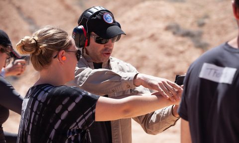 Jason Hanson on the gun range with a student.