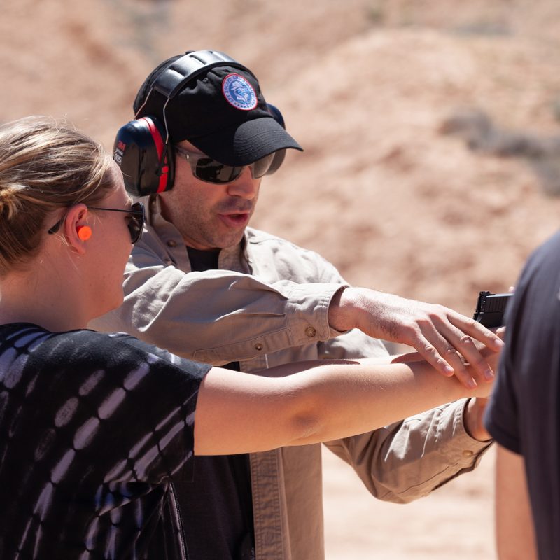 Jason Hanson on the gun range with a student.