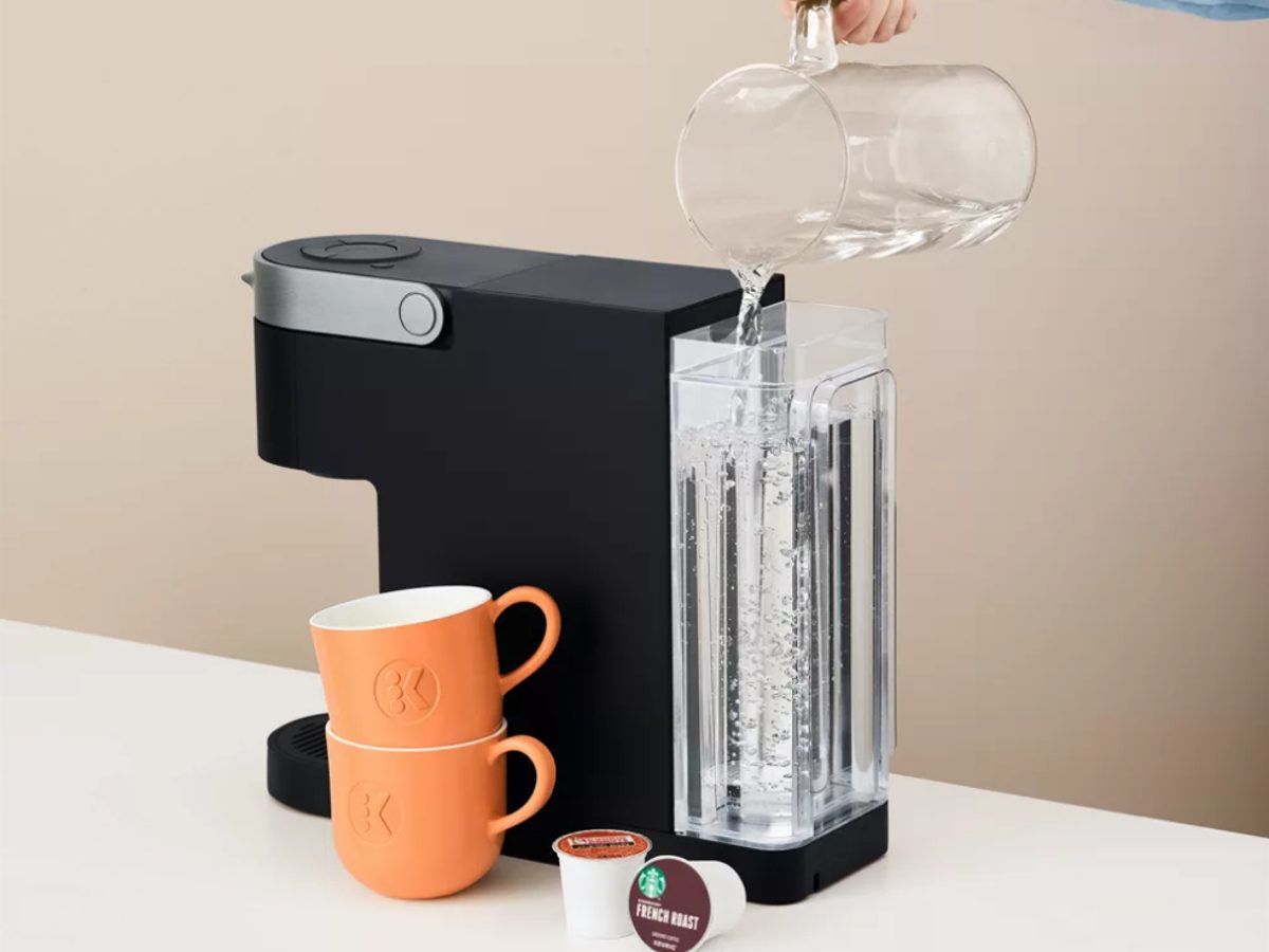 Keurig K-Slim single serve coffee maker filling water reservoir.