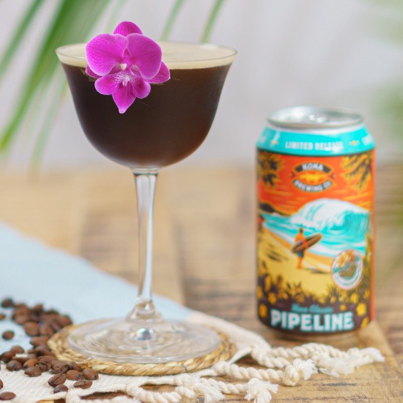Kona Pipeline porter espresso martini with purple flower garnish next to kona porter beer.
