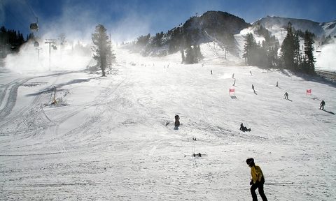 Skiers and snowboarders on slopes.