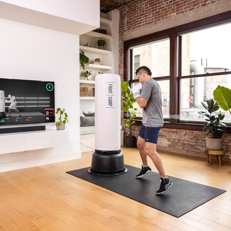 Man doing FightCamp in his living room with video.