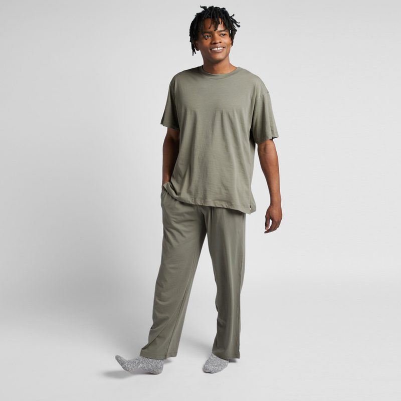A man wearing an organic cotton tee from Parachute against a studio background.