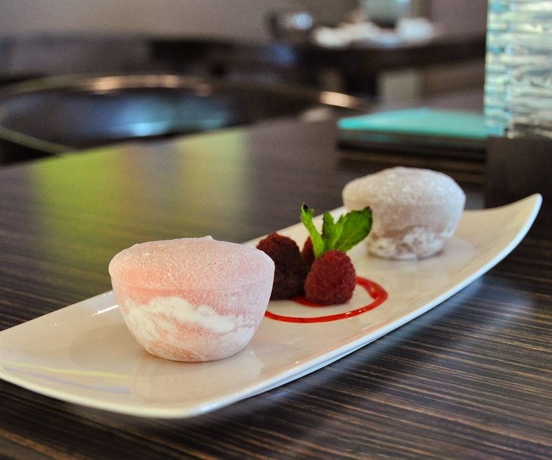 Mochi served on a white plate placed on a table.