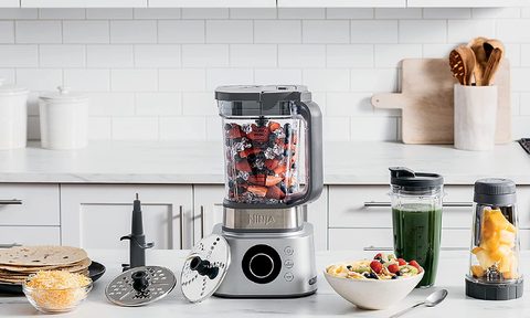 Ninja FNinja Foodi Ultimate System on a white marble kitchen counter.