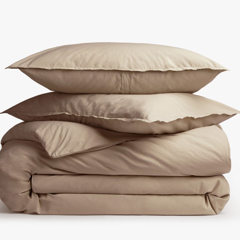 A duvet cover and two pillows stacked on top of each other.