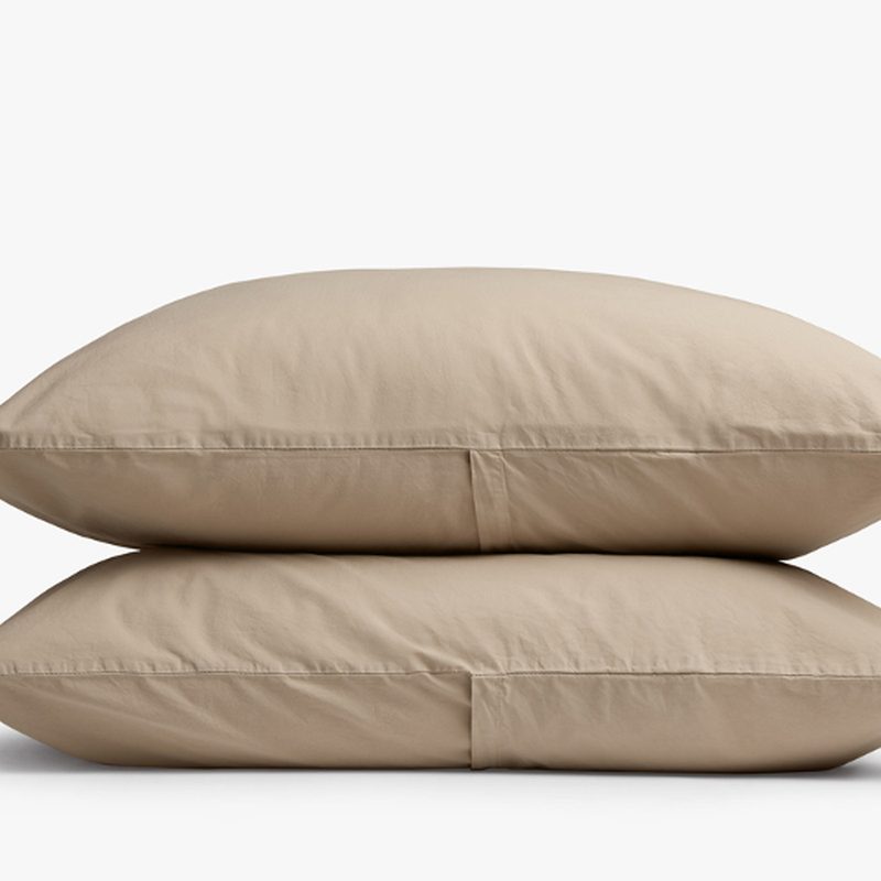 Two pillows covered in organic cotton pillowcases from Parachute.