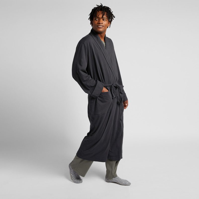 A man wearing an organic cotton robe from Parachute.
