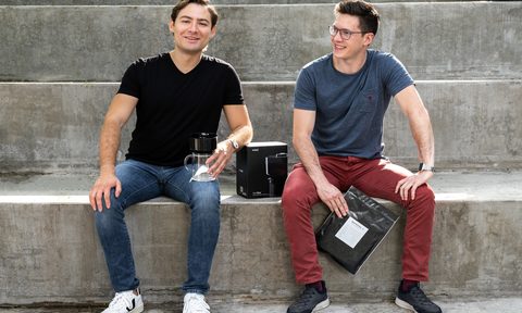 Otto Becker and Eduardo Umaña sitting on the stairs.