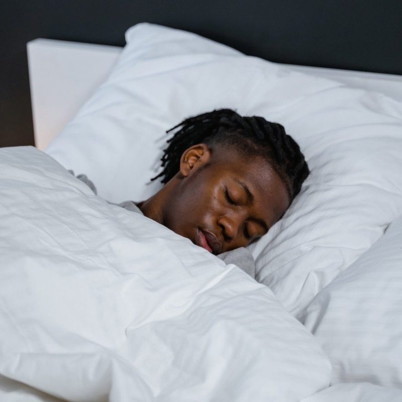 A man sleeping in his bed