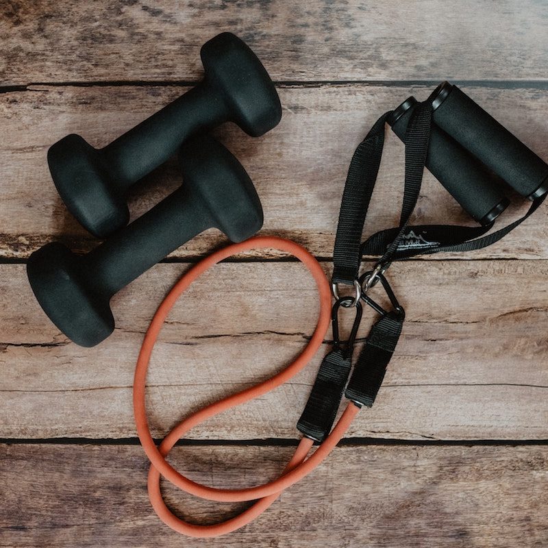 Pair of dumbbells and a resistance band with handles.