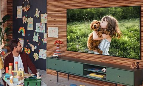 Family watching videos on Samsung 55-inch Class Q60A 4K TV.