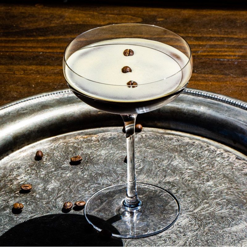 Skrewball peanut butter espresso martini sitting on a silver serving tray.