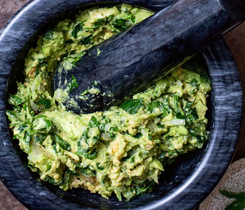 Smoky guacamole in a mortar and pestle.