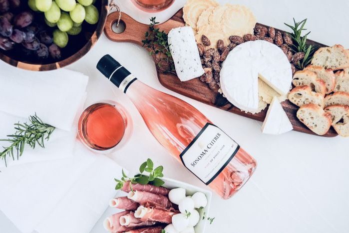 Bottle of Sonoma Cutrer Rose shown on a table with charcuterie board.