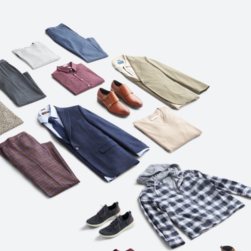 A variety of men's fashion essentials on the floor.