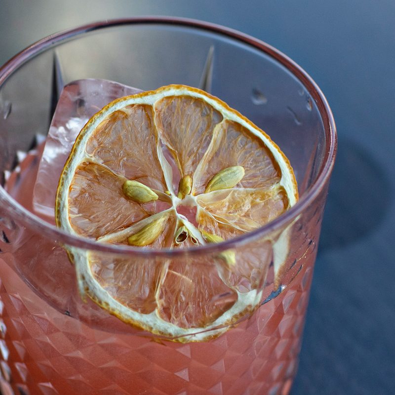 Tea Trade cocktail with dried lemon slice.