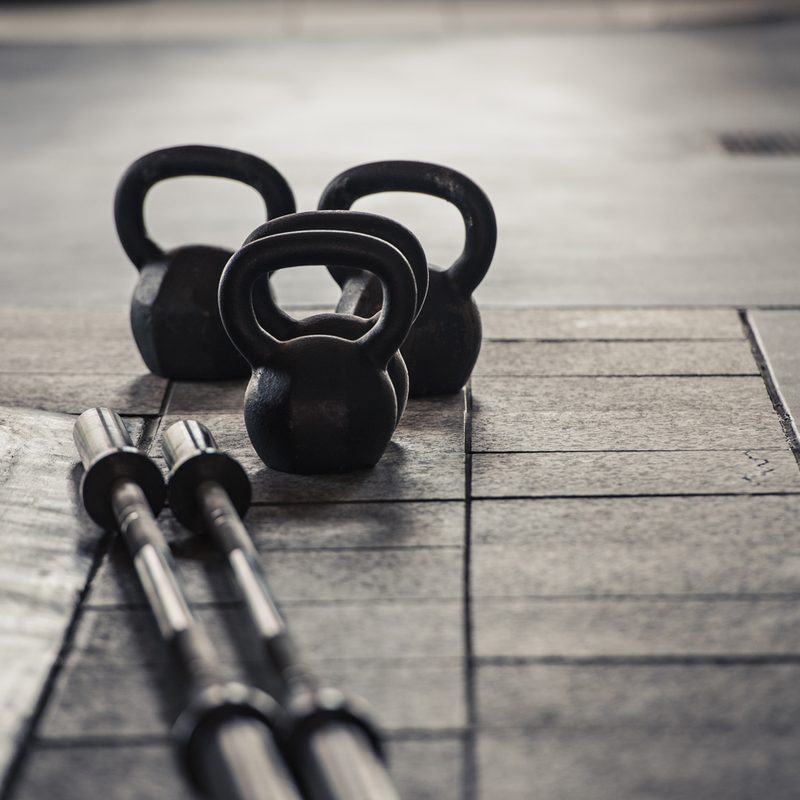 Barbells and kettlebells on the floor.