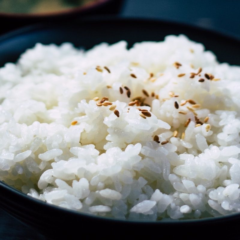 Bowl of white rice with sesame seeds.