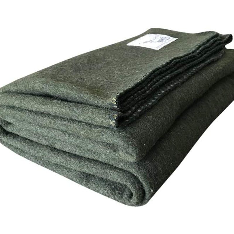 A folded woolen blanket in olive green from Woolly Mammoth on a white background