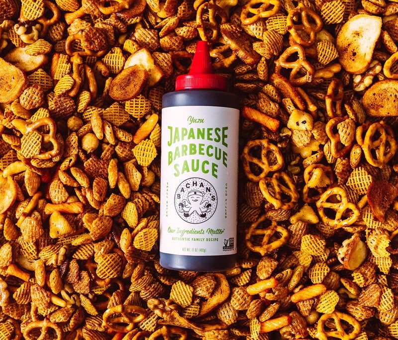 Bottle of Bachan's Japanese Barbecue sauce in the middle of Chex mix