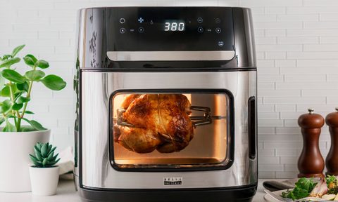 12.6-quart Bella Pro Series digital air fryer oven cooking rotisserie chicken.