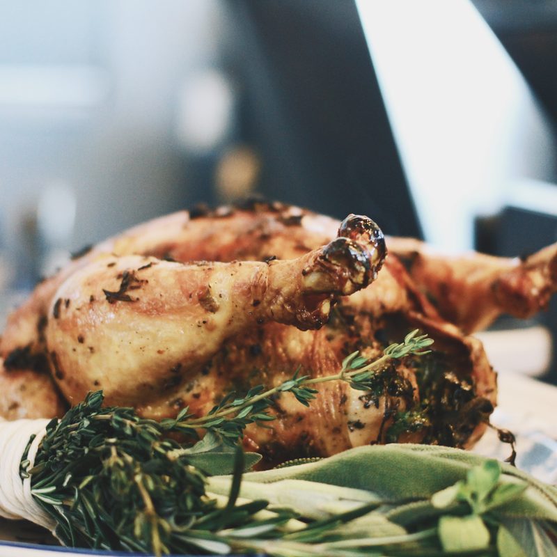 A whole roasted chicken served on a plate.