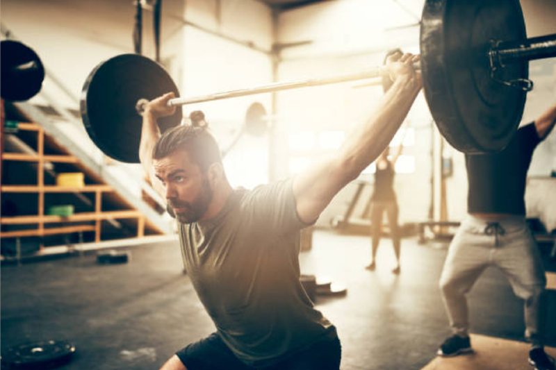 Man overhead squatting with a barbell